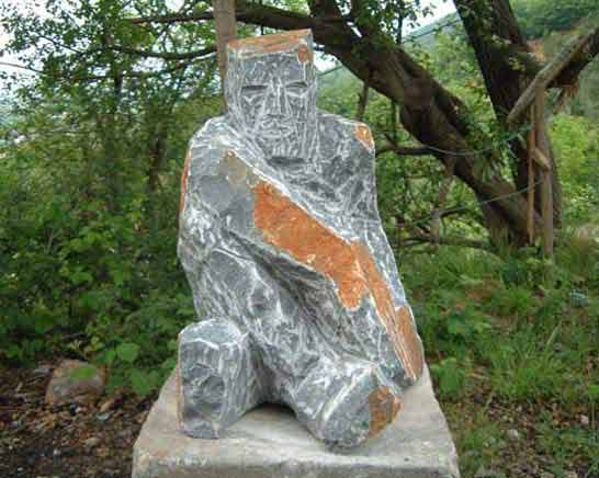 Sitting figure in front of studio